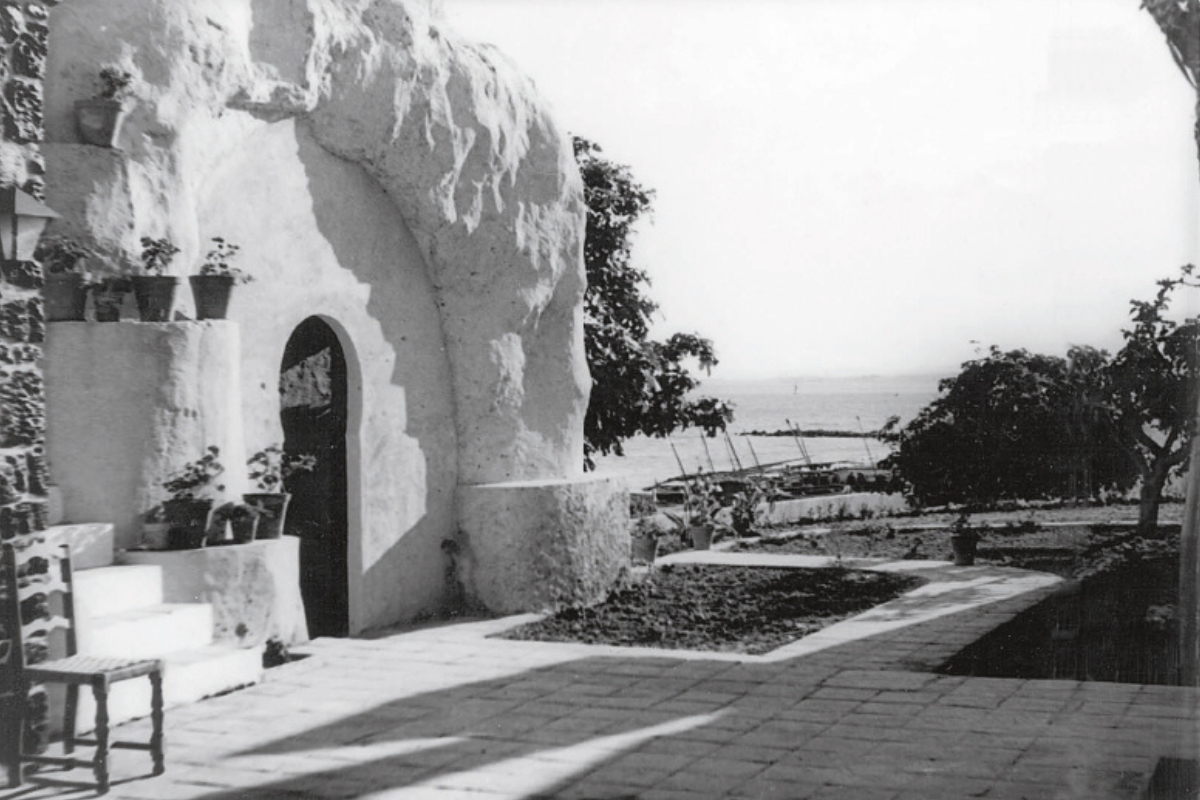 a stone building with a door and a stone path