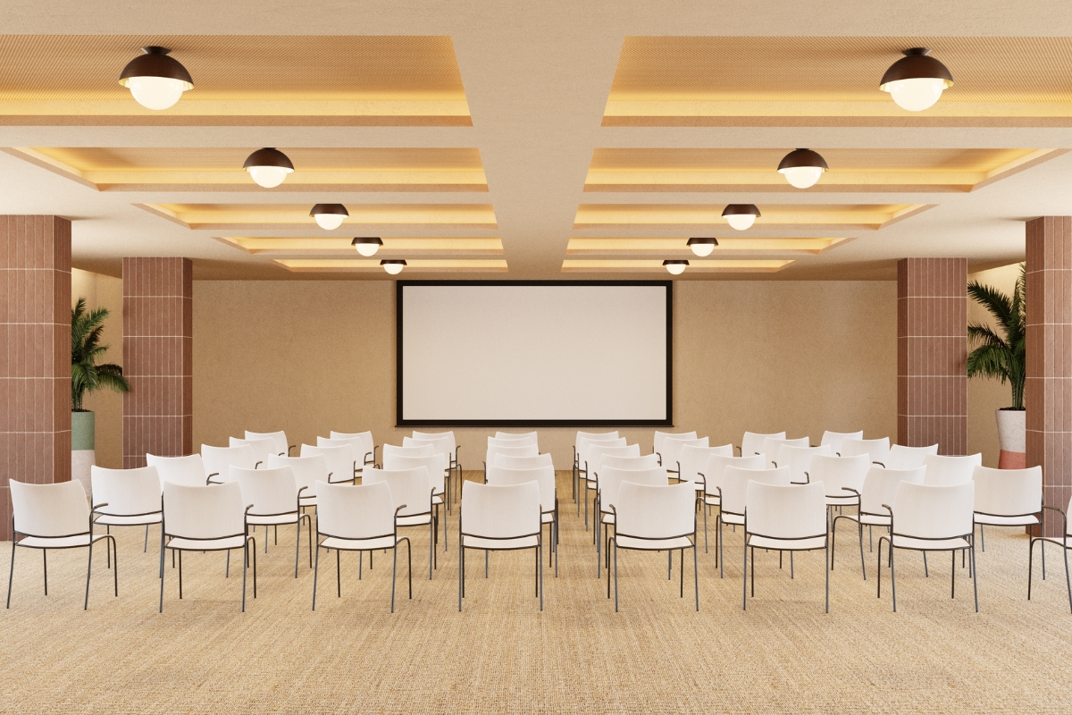a room with white chairs and a screen
