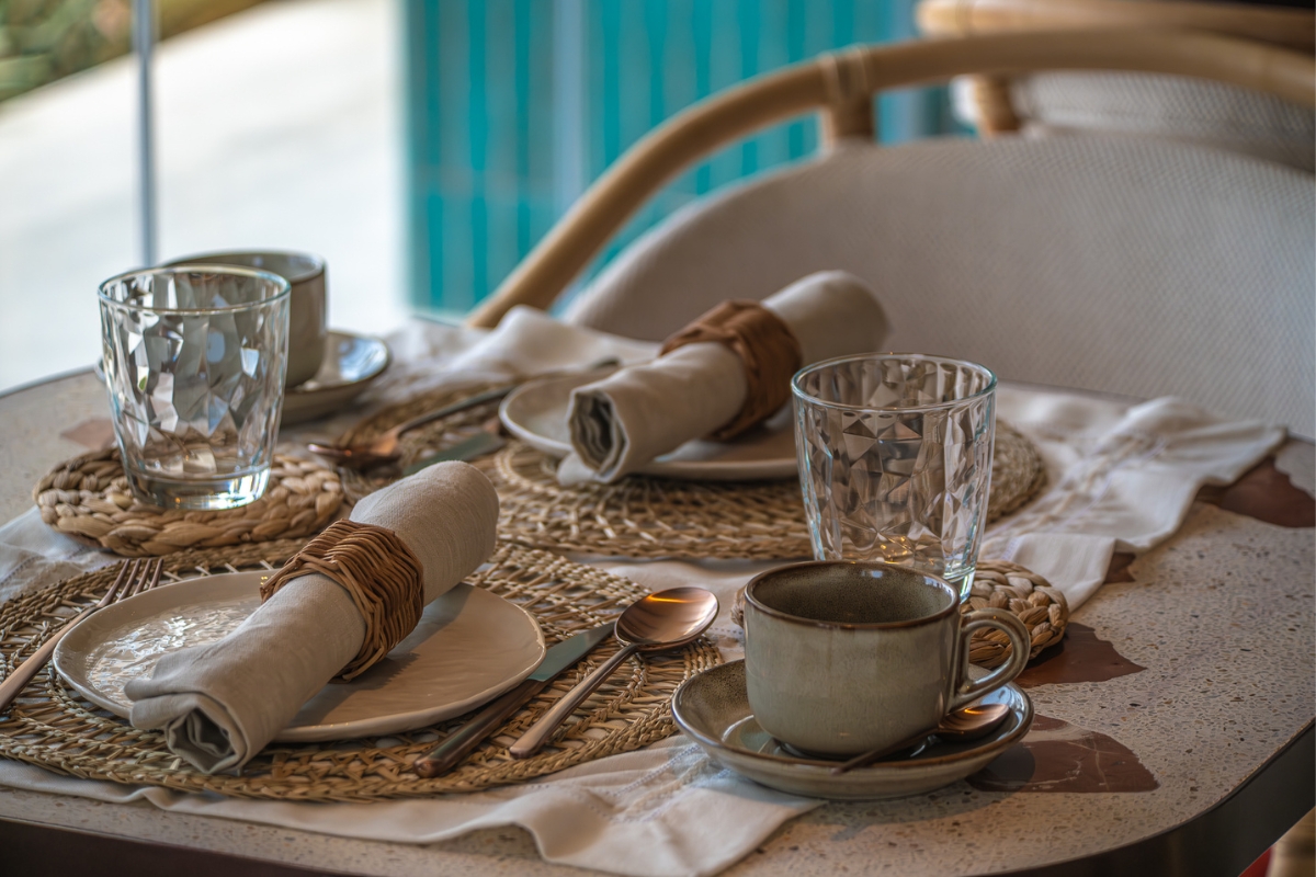 a table set with plates and cups and napkins