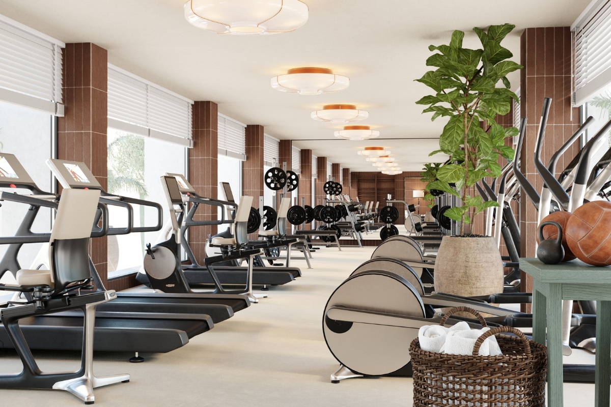 a room with exercise equipment and a plant