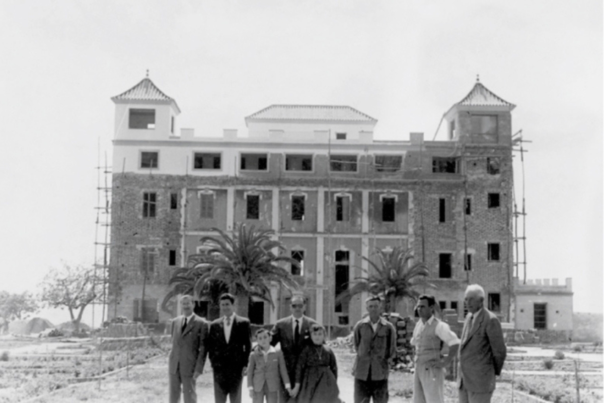 a group of men standing in front of a building