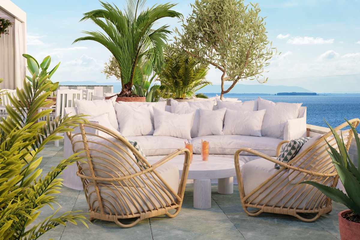 a white couches and a table on a patio
