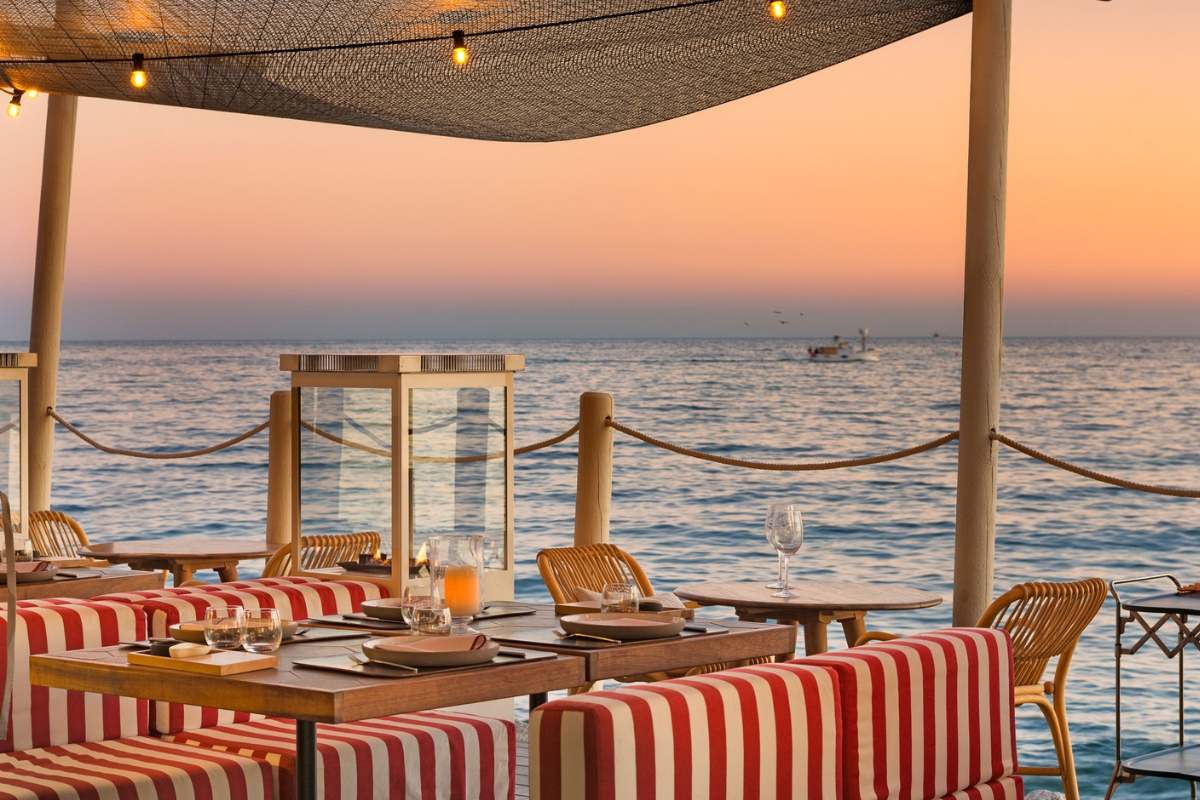 a table and chairs on a beach