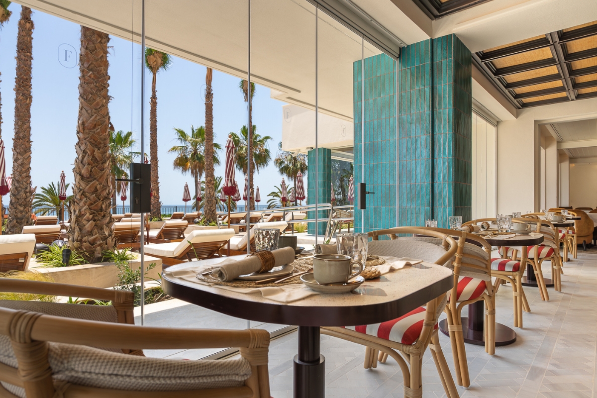 a table with chairs and a glass wall