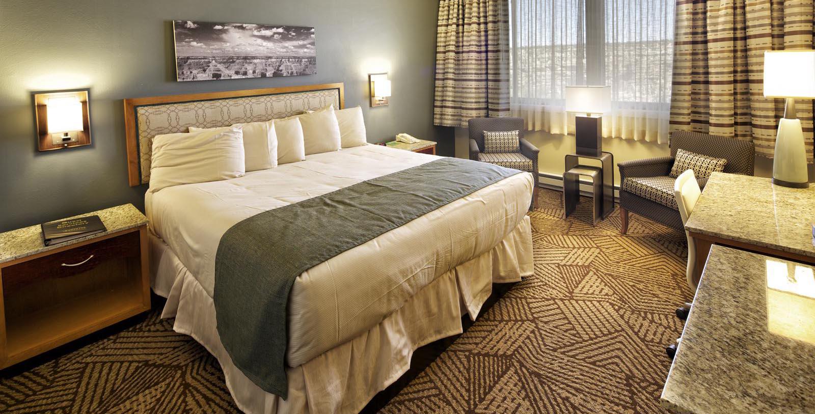 a hotel room with a bed and a chair