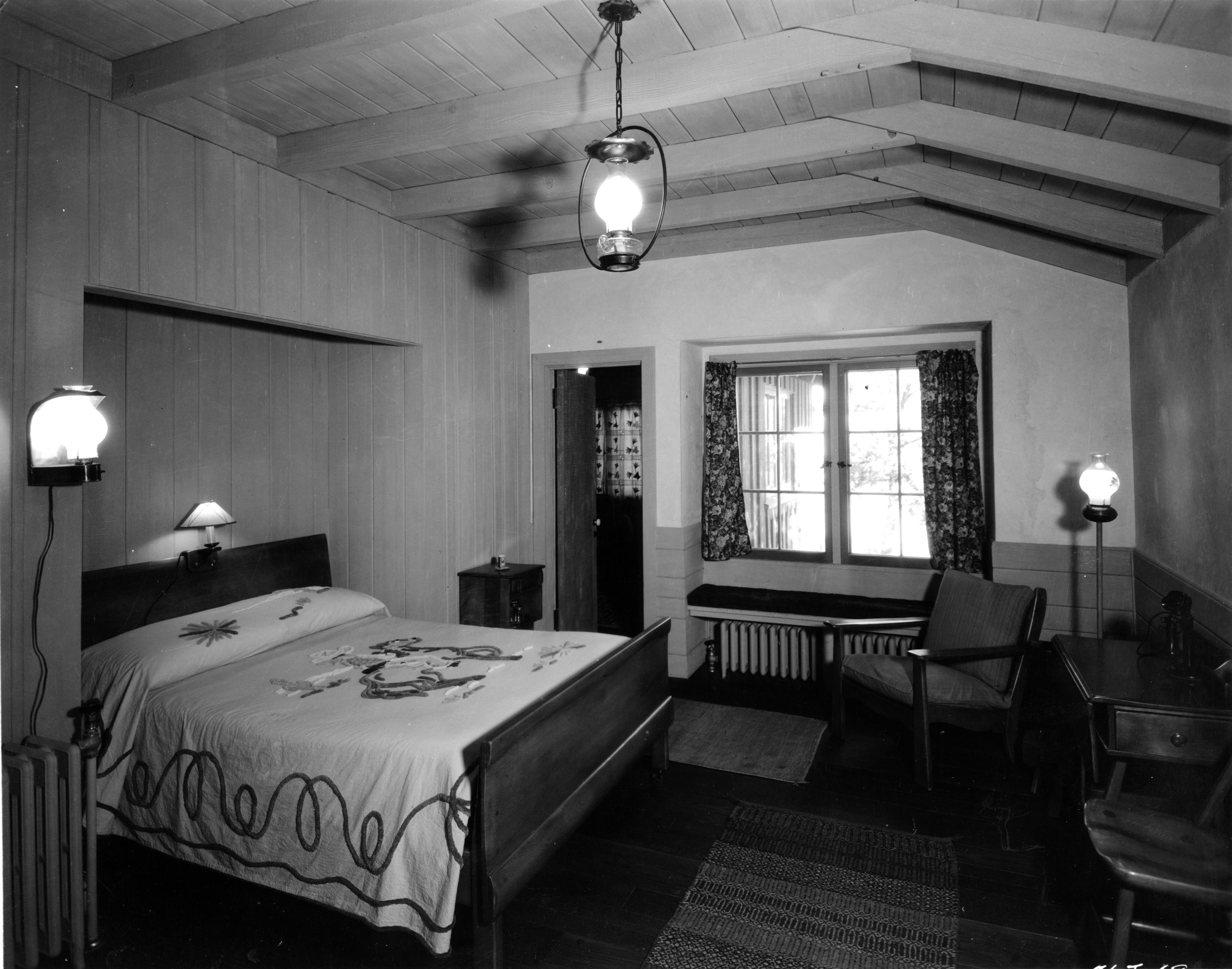 a bedroom with a bed and chairs