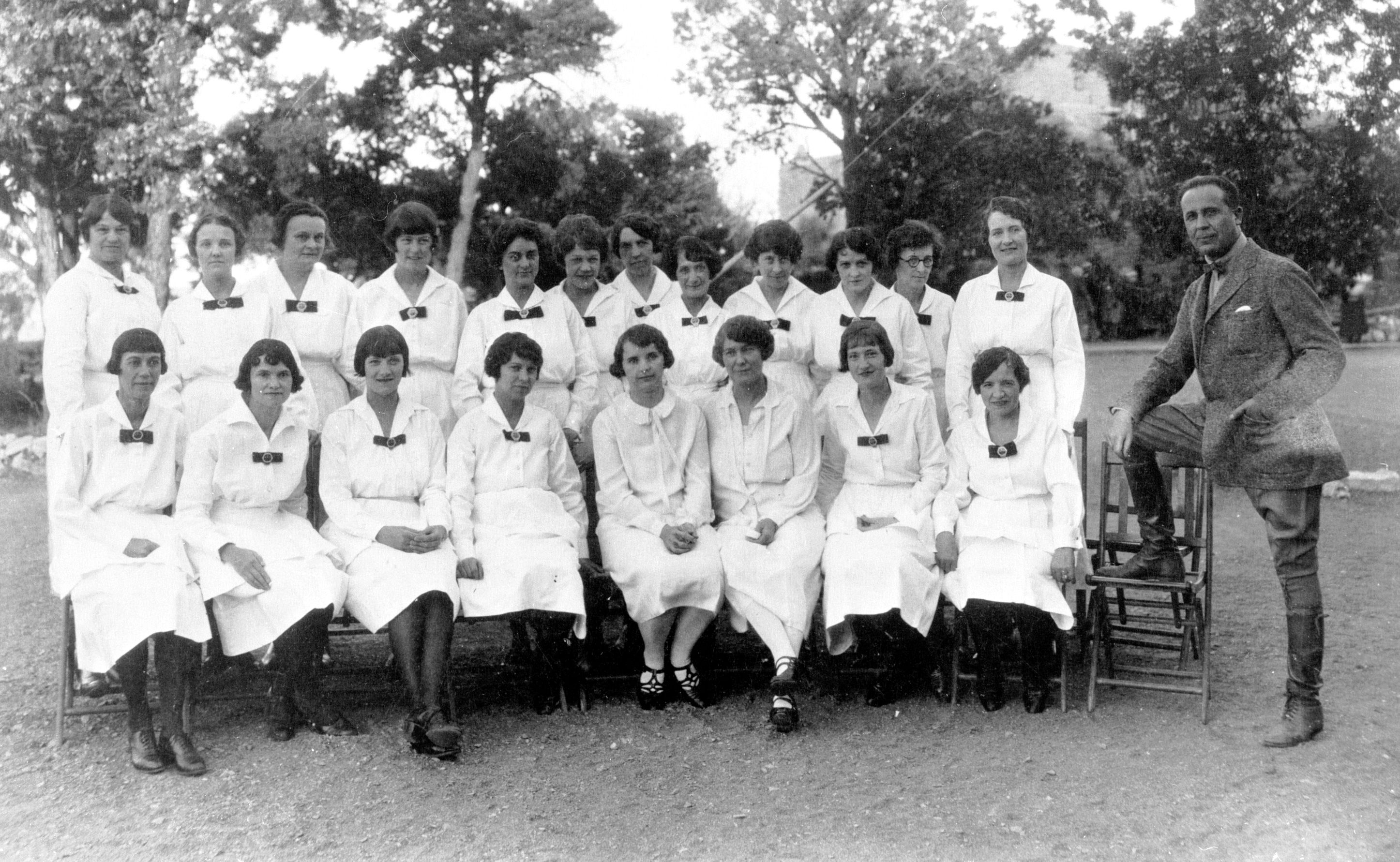 a group of women in white dresses
