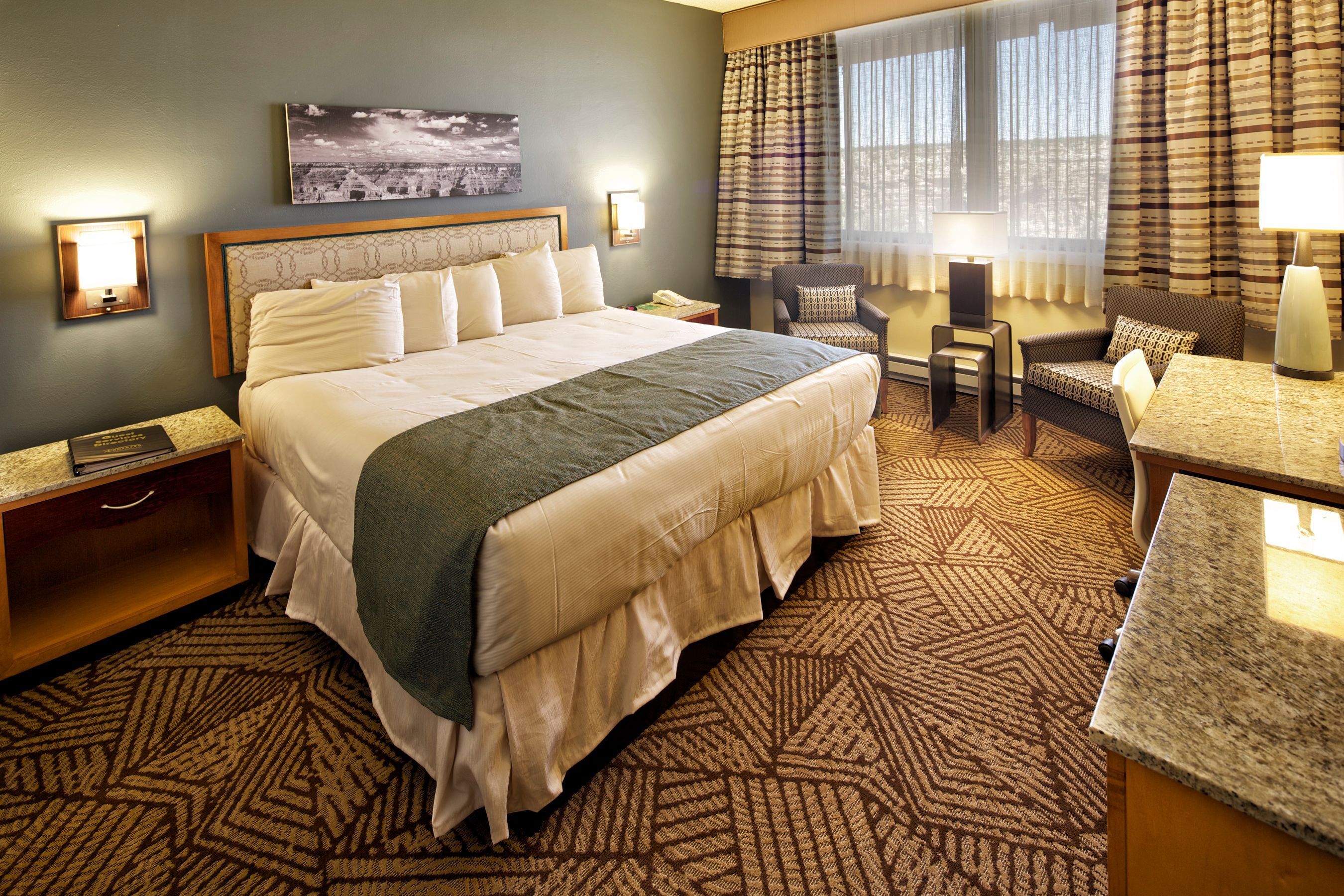 a hotel room with a bed and a television