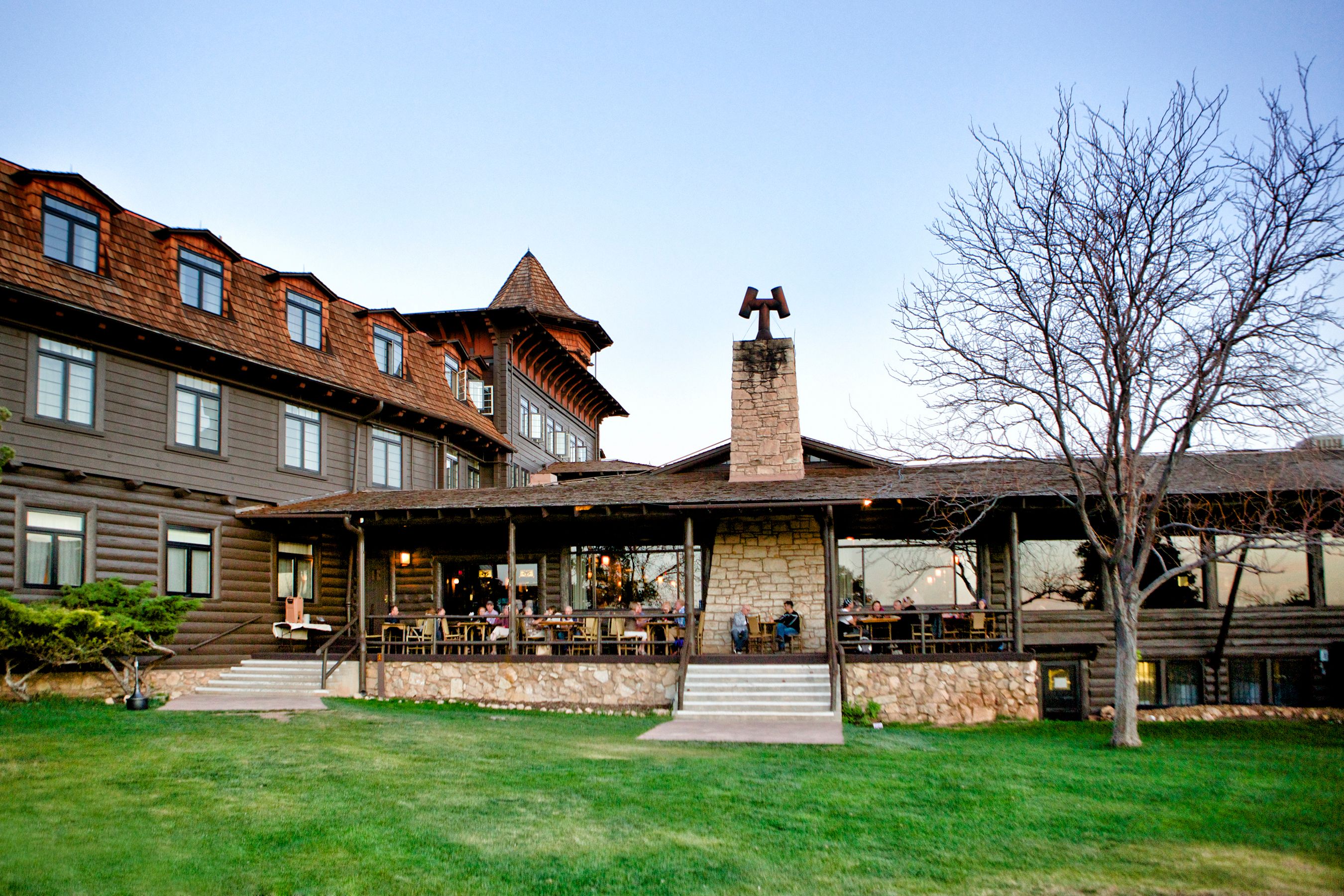 a building with a porch and a lawn