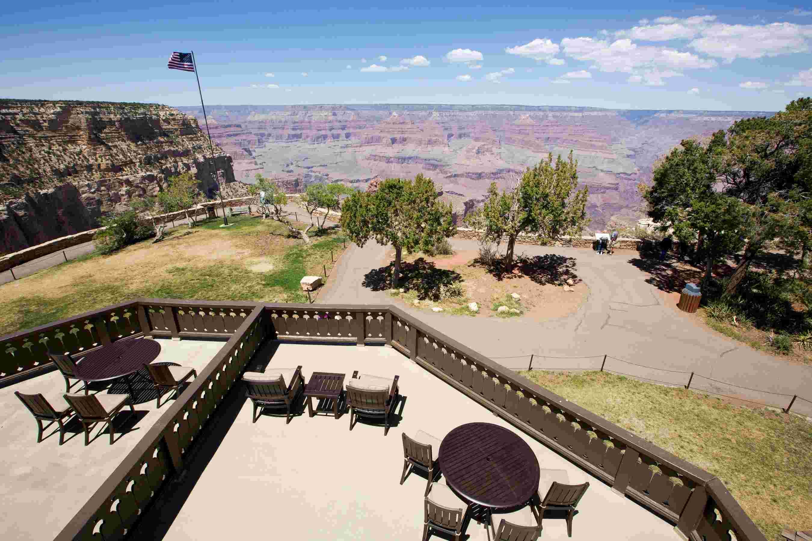 a table and chairs on a deck overlooking a canyon