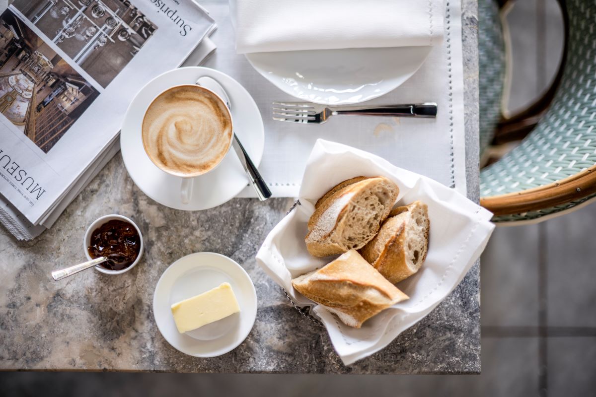 a plate of food and a cup of coffee on a table