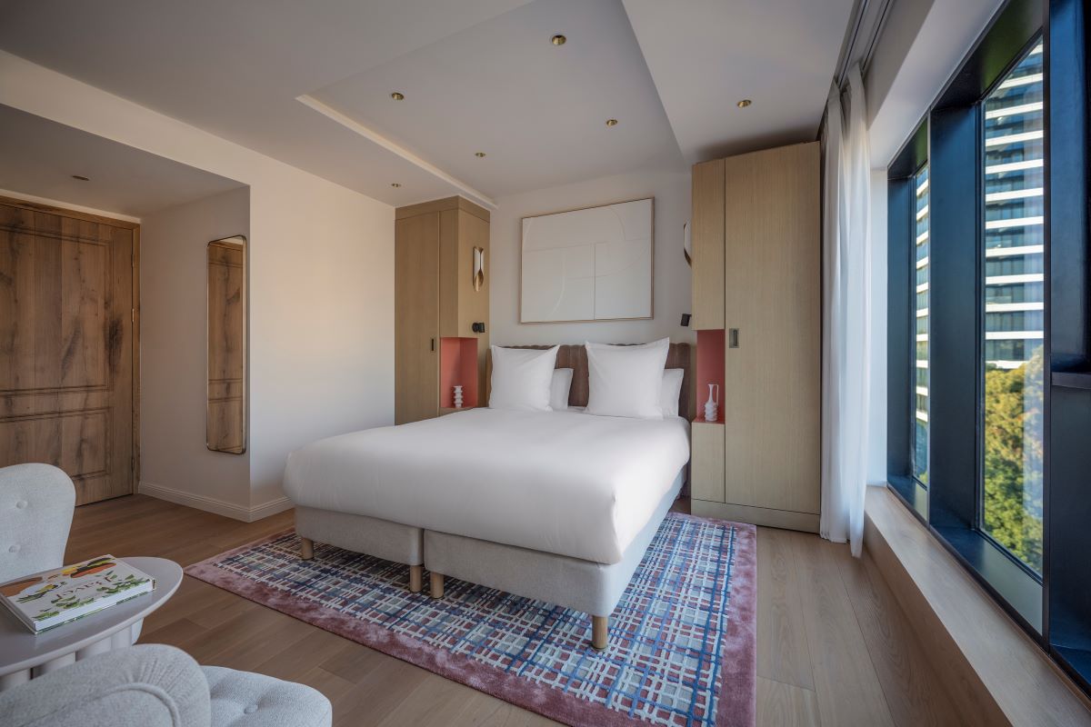 a bedroom with a bed and a rug