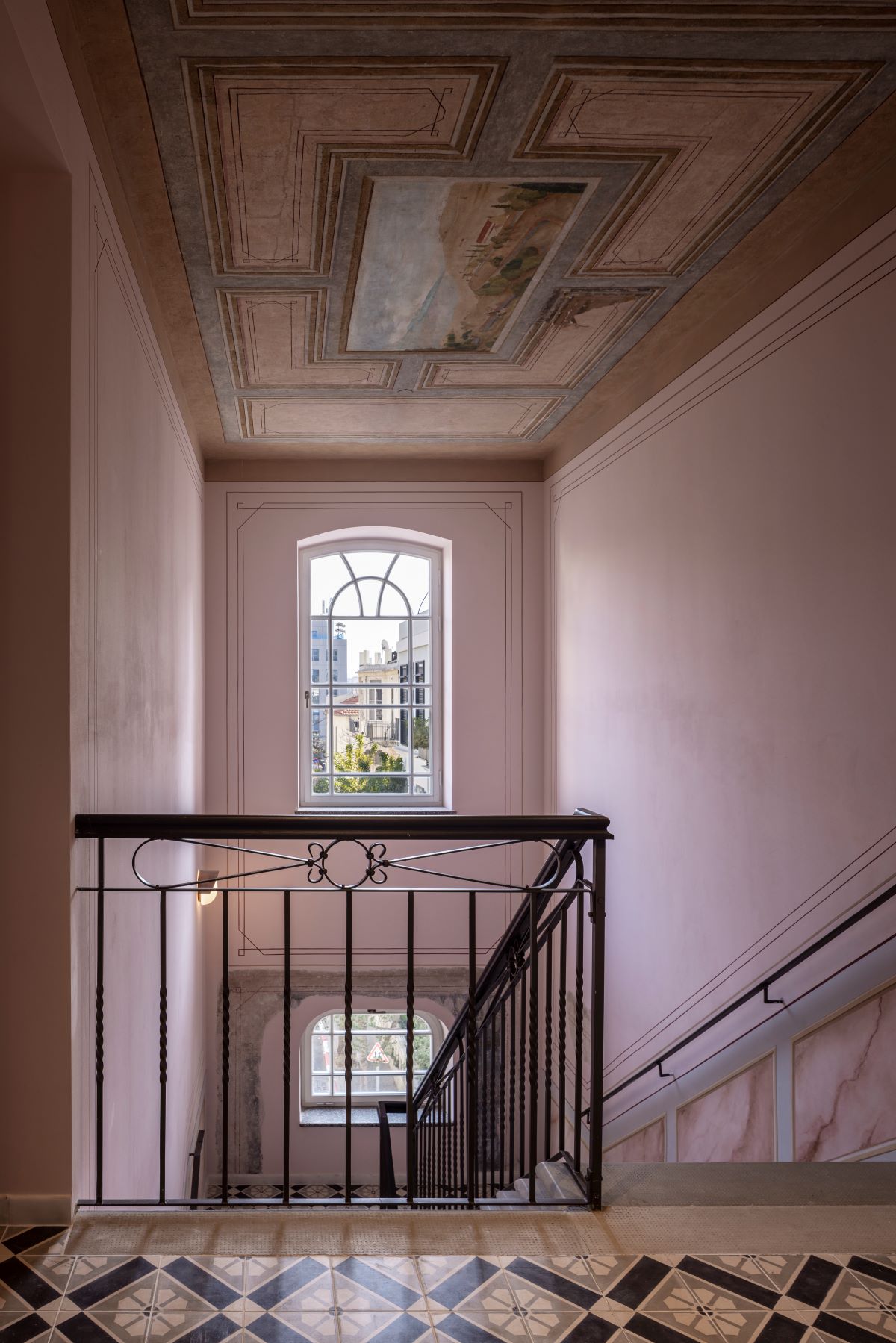 a staircase with a railing and a window