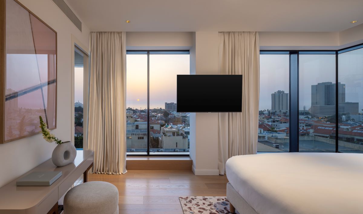 a room with a television and a view of a city