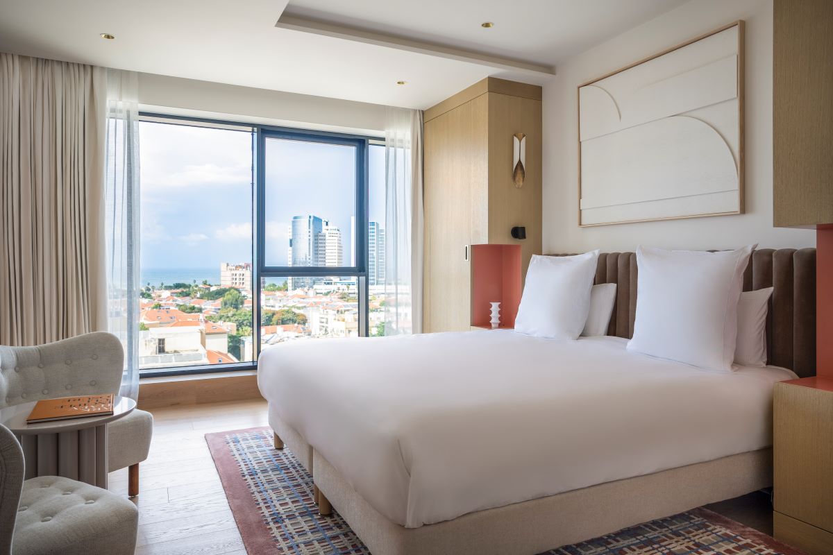 a bedroom with a large bed and a chair