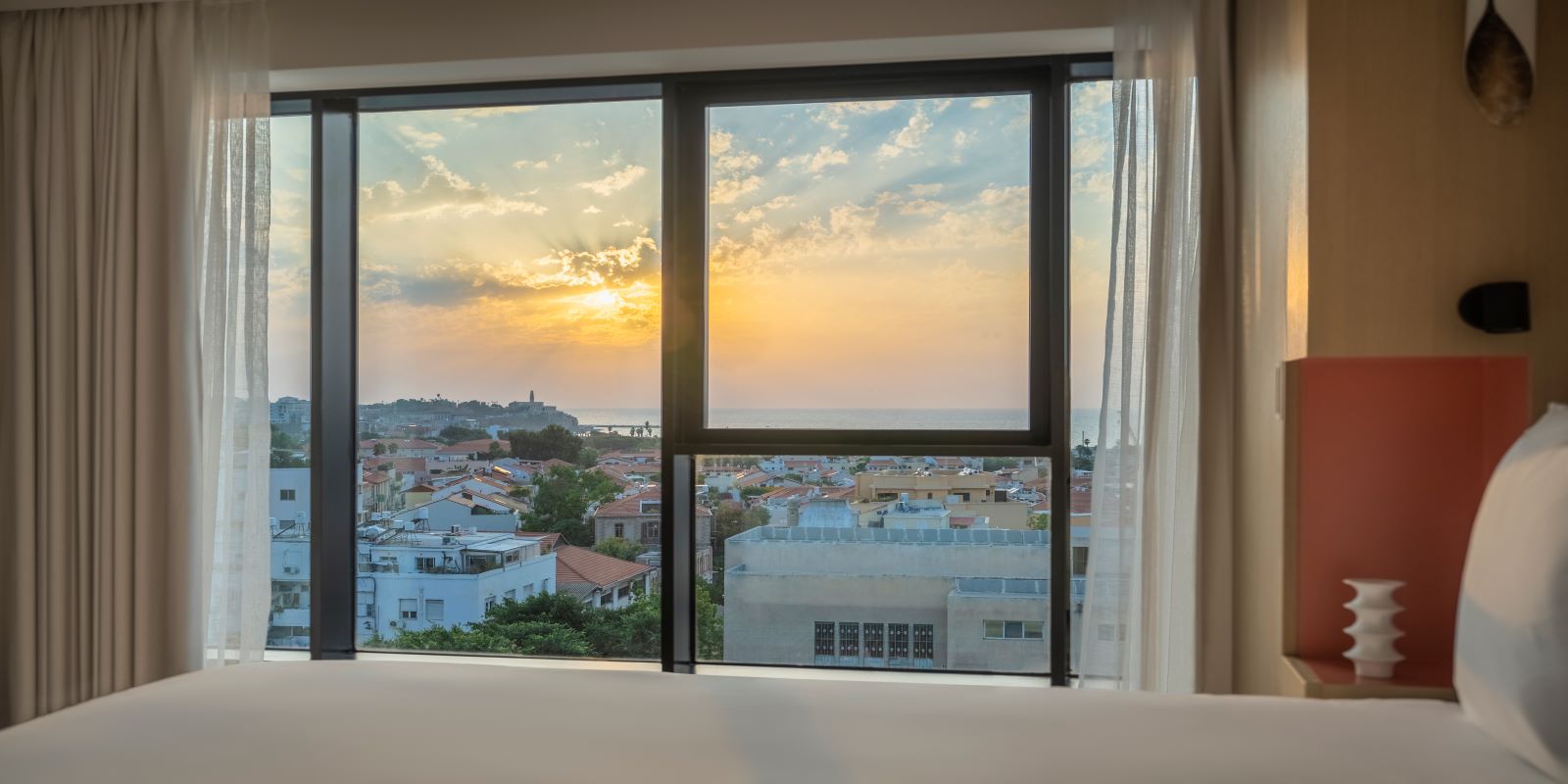 a window with a view of a city and water