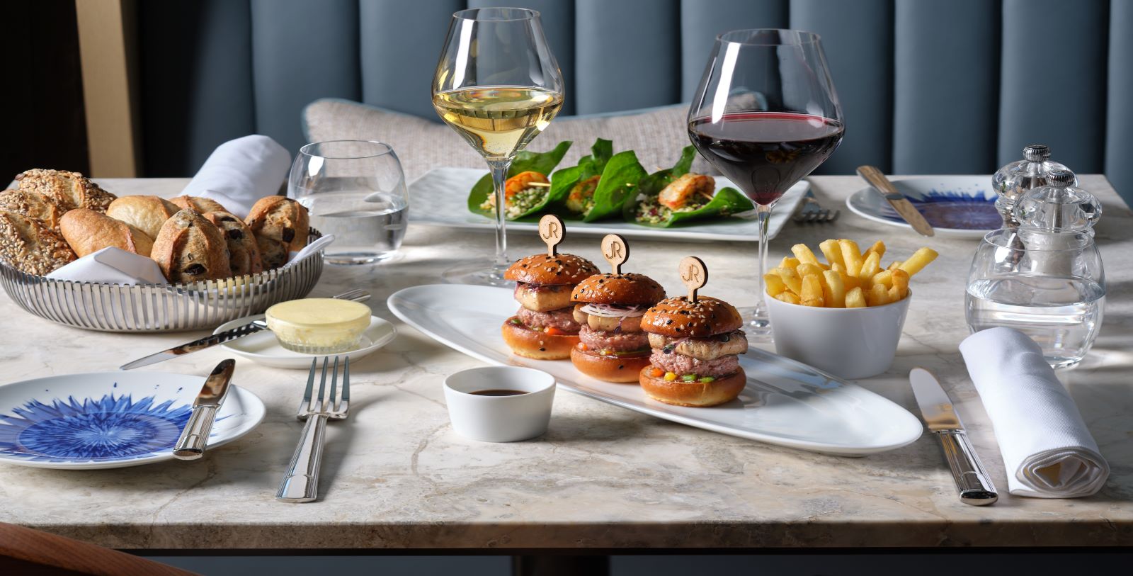 a plate of burgers and french fries on a table