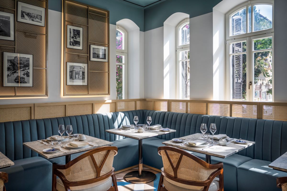 a booth seating with tables and chairs in a restaurant