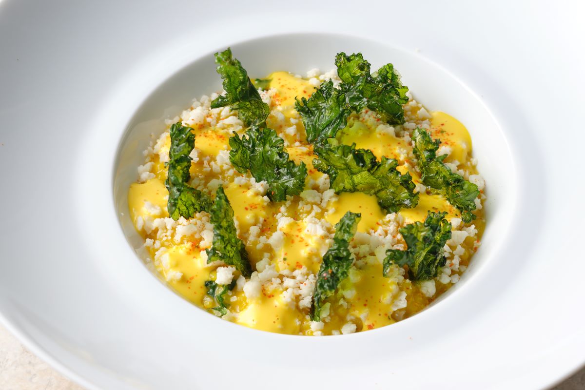 a bowl of food with green leaves
