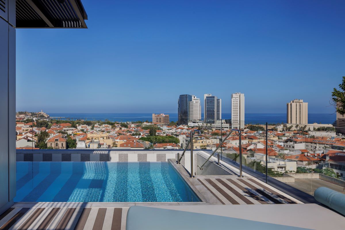 a pool with a view of a city and buildings