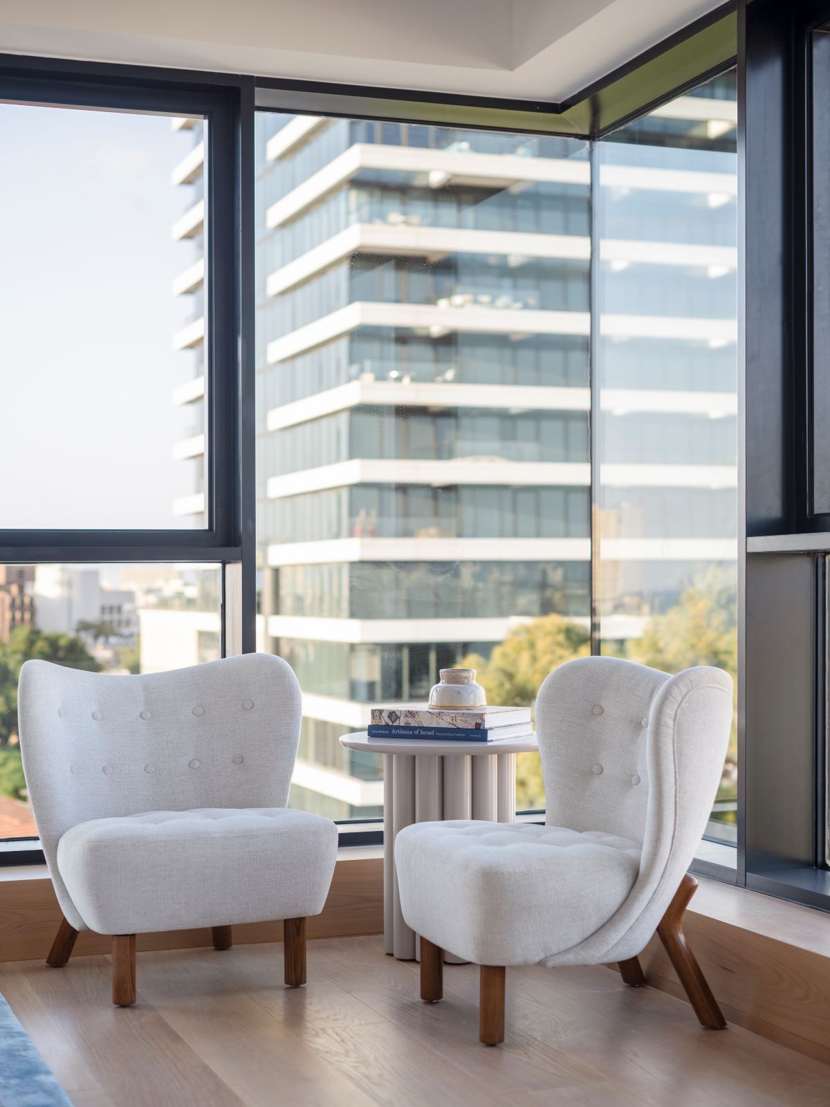 a white chairs and a table in front of a large window