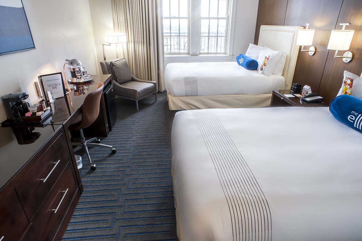 a room with two beds and a desk