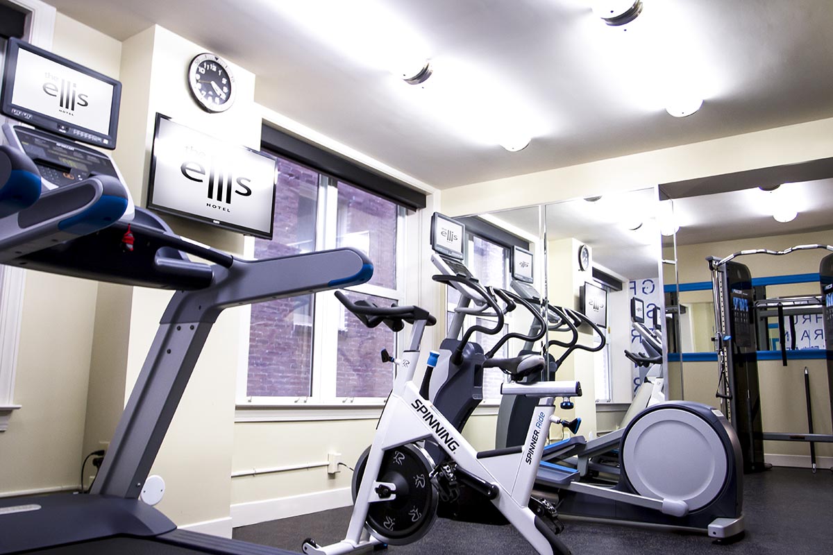 a room with exercise bikes and a mirror
