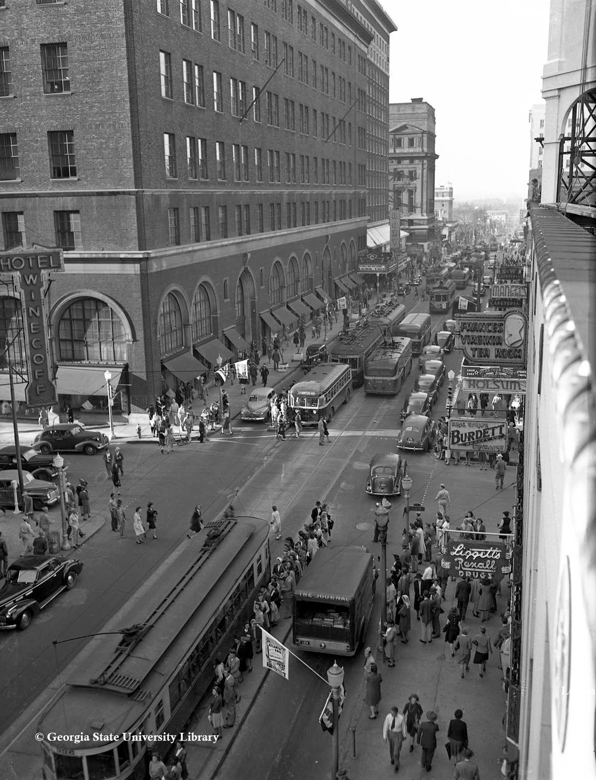 a street with buses and people