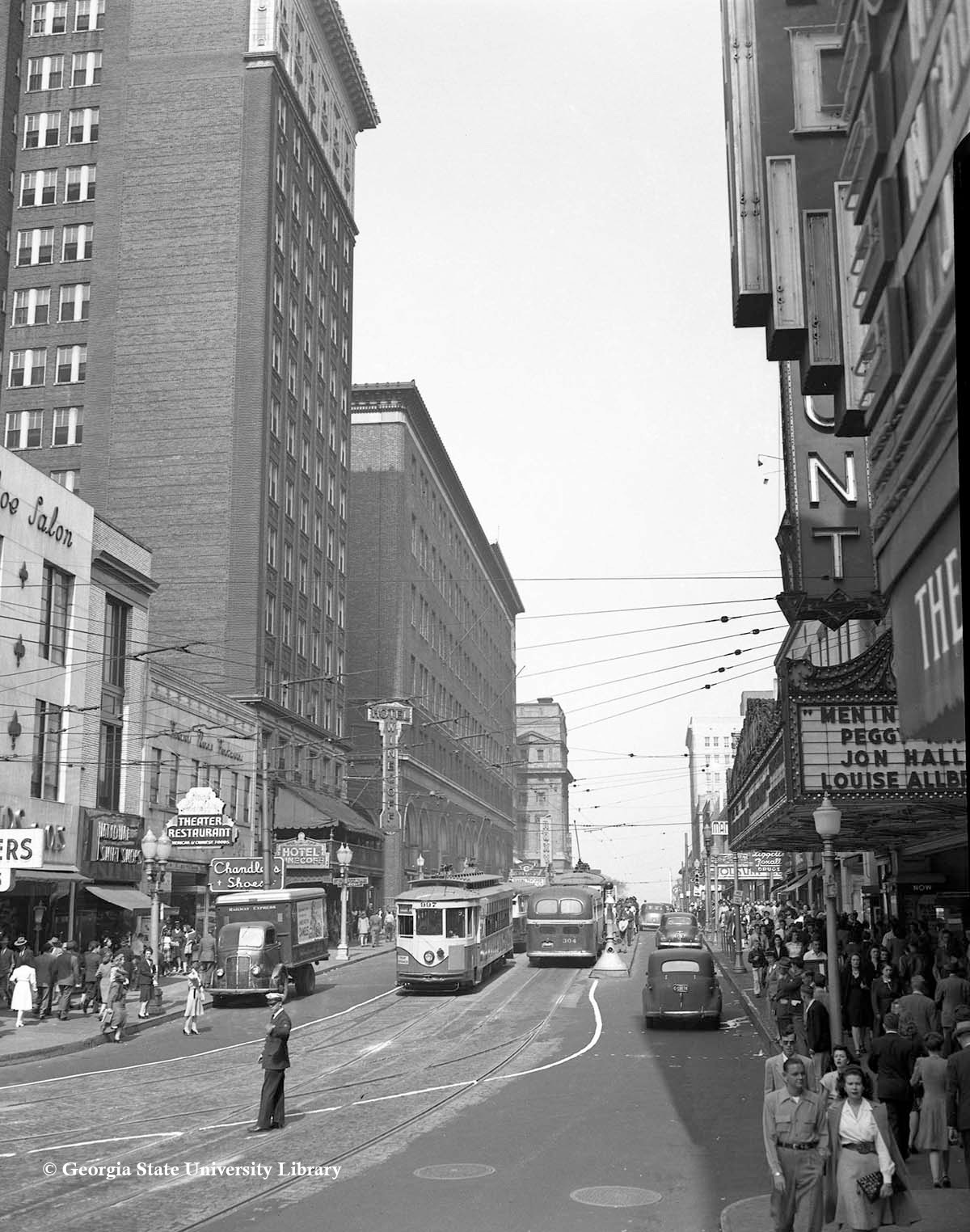 a street with trolleys and people in the background