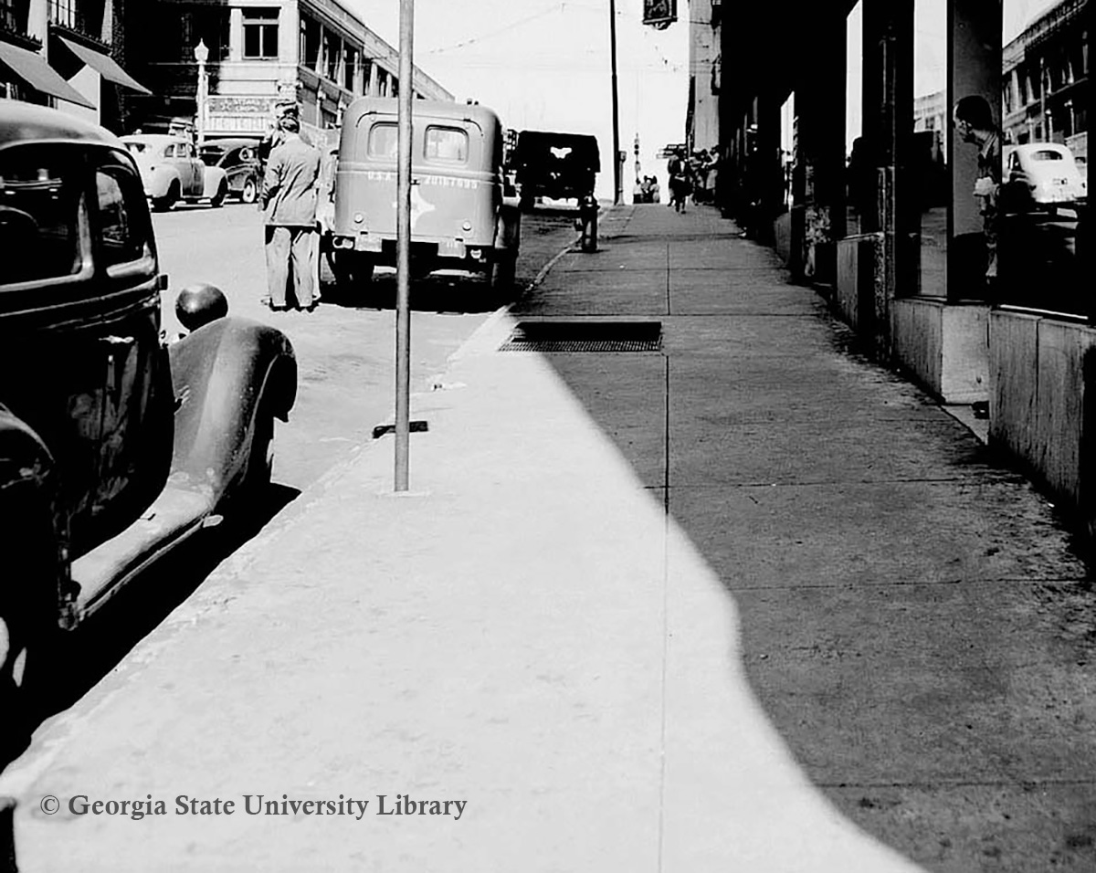a street with cars and people