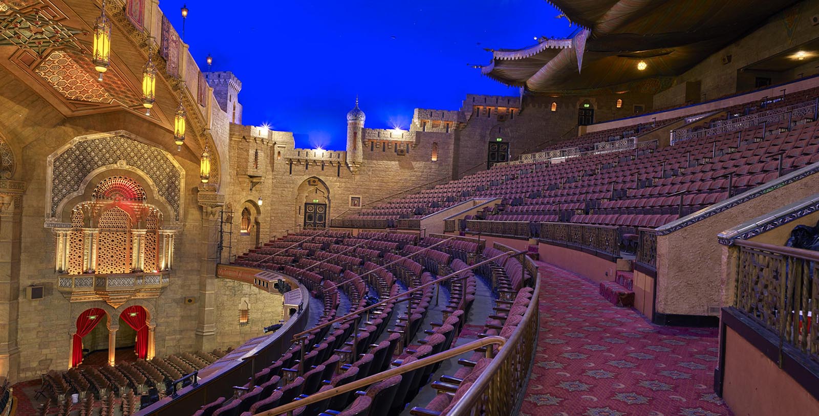 a large theater with red seats