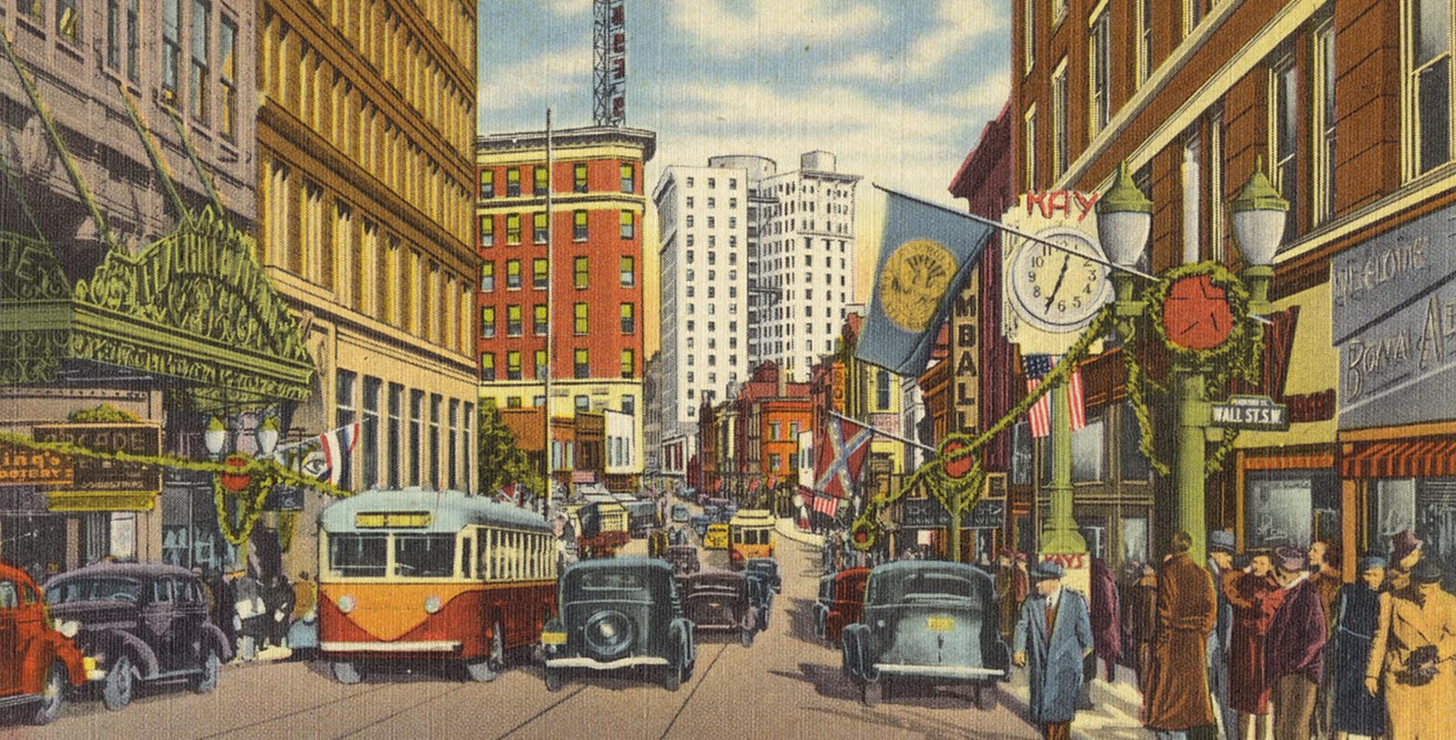 a street with cars and people in the city