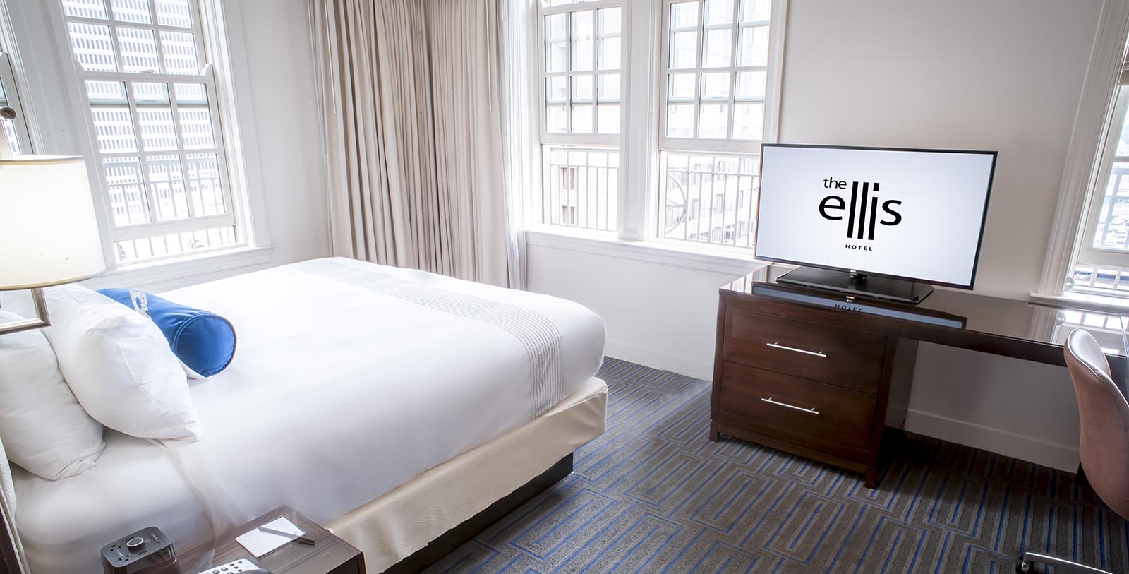a bedroom with a tv and a dresser