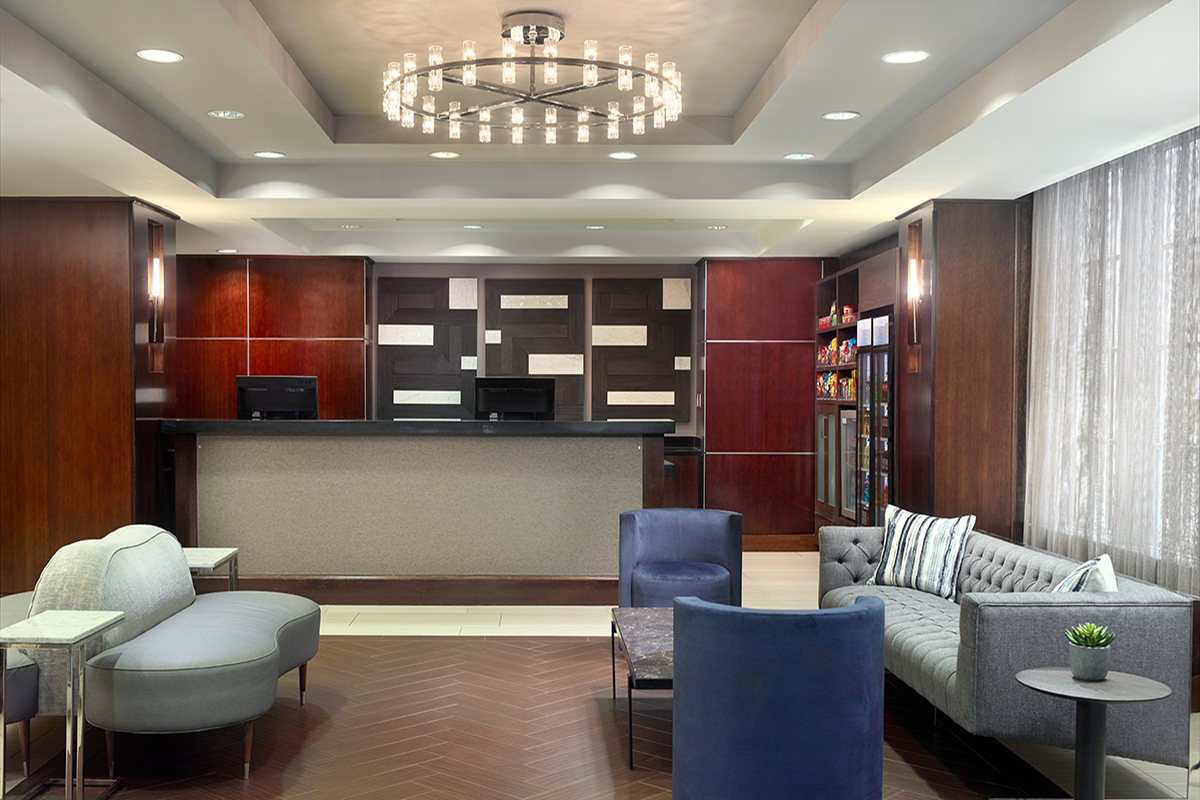 a lobby with a chandelier and couches