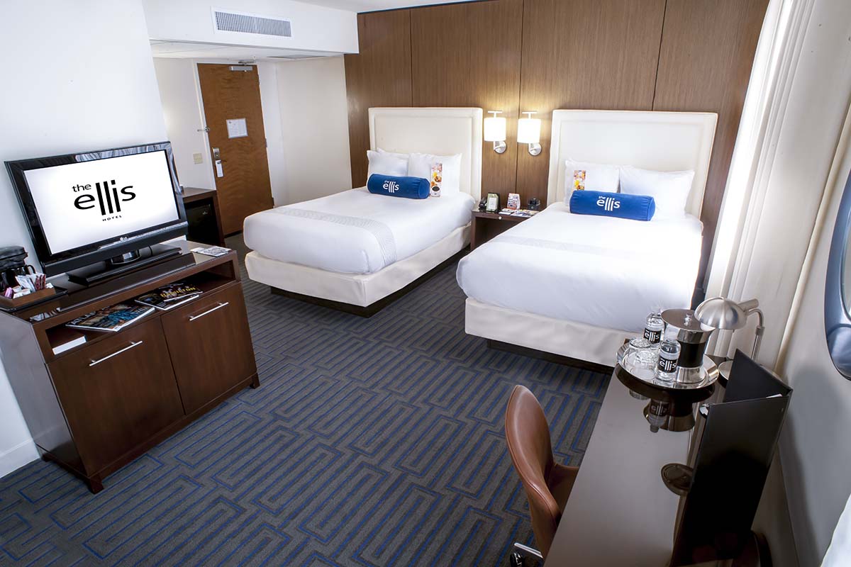 a room with two beds and a television