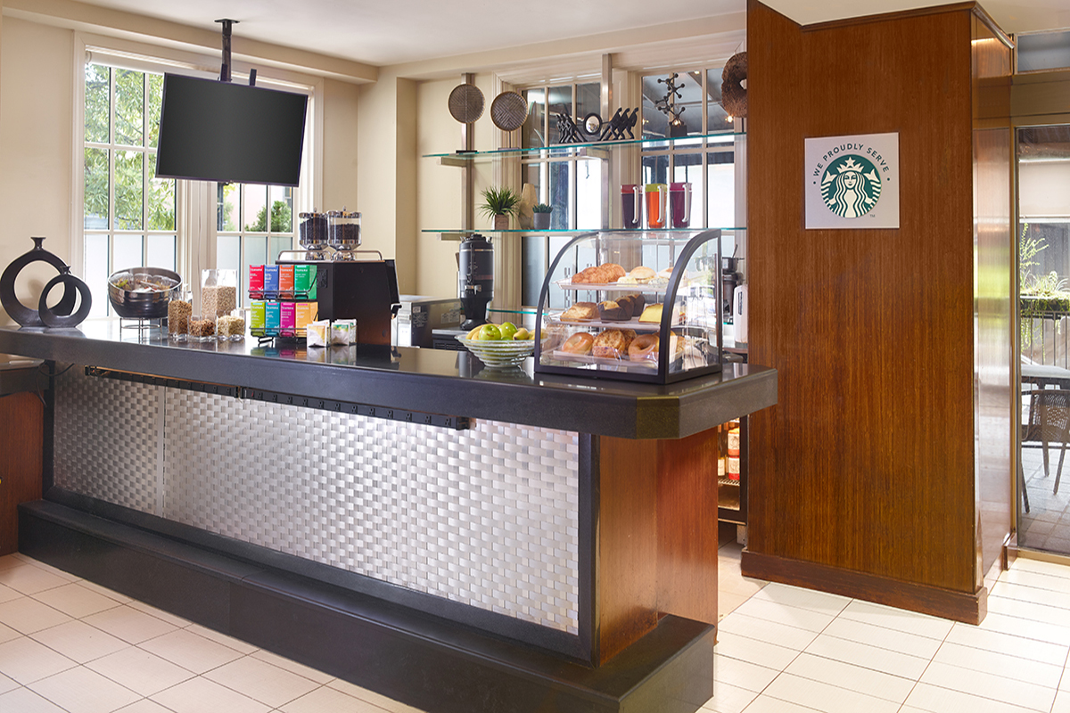 a coffee shop counter with a display case