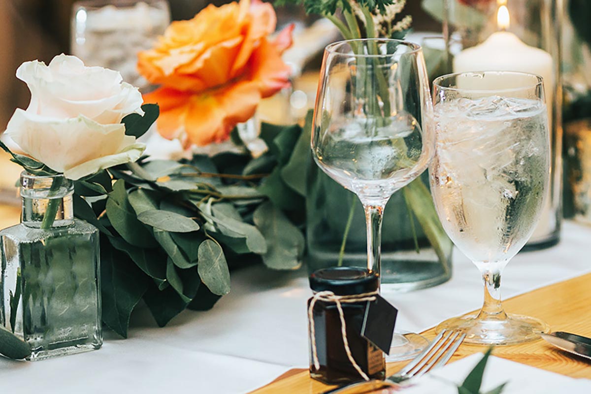 a table with flowers and glasses