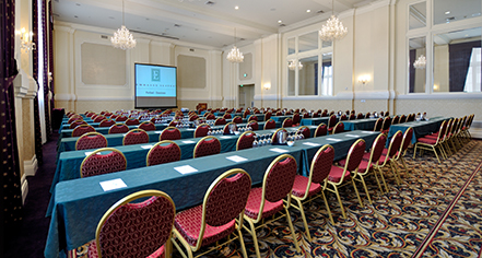 a room with long tables and chairs