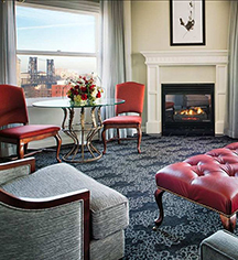 a room with a fireplace and chairs