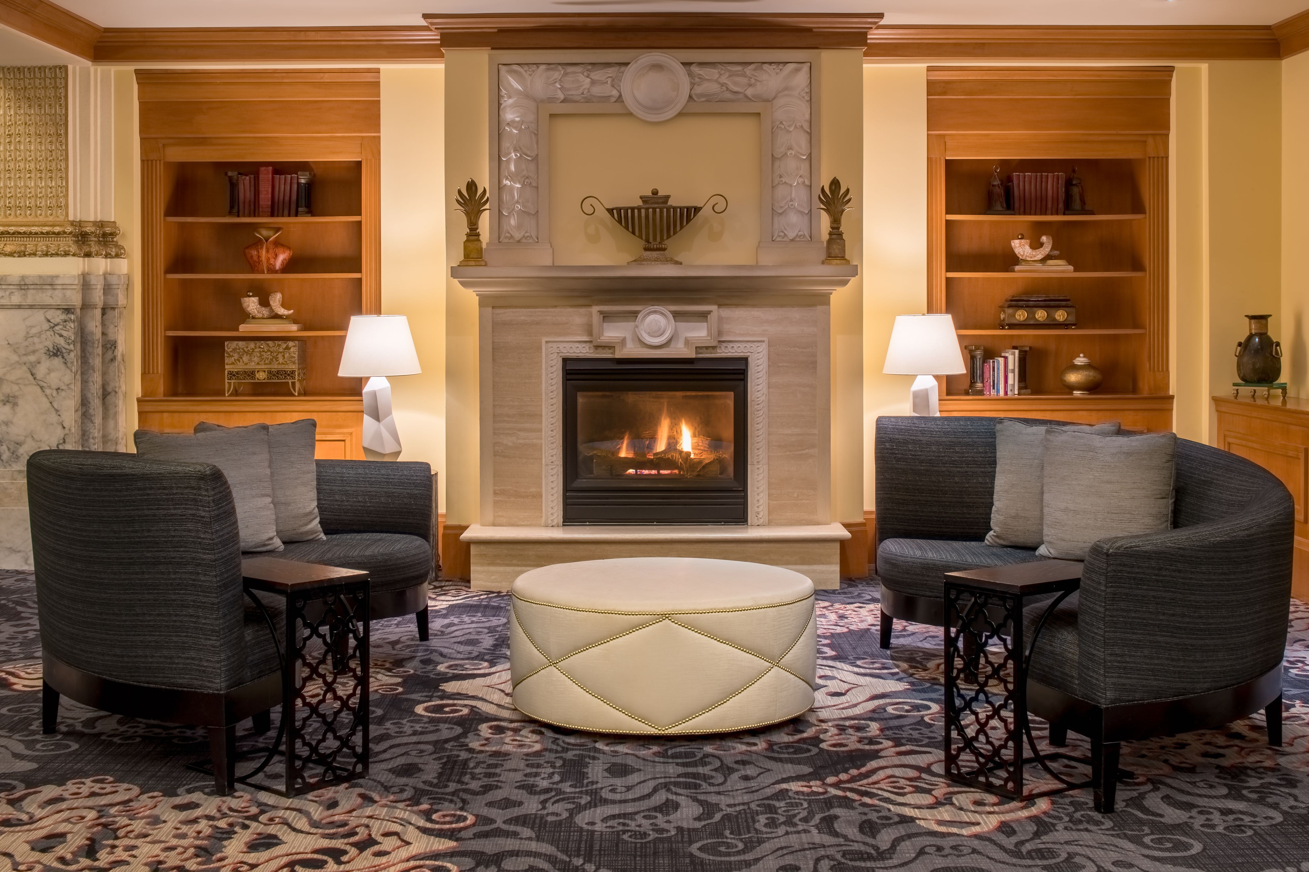 a room with a fireplace and chairs