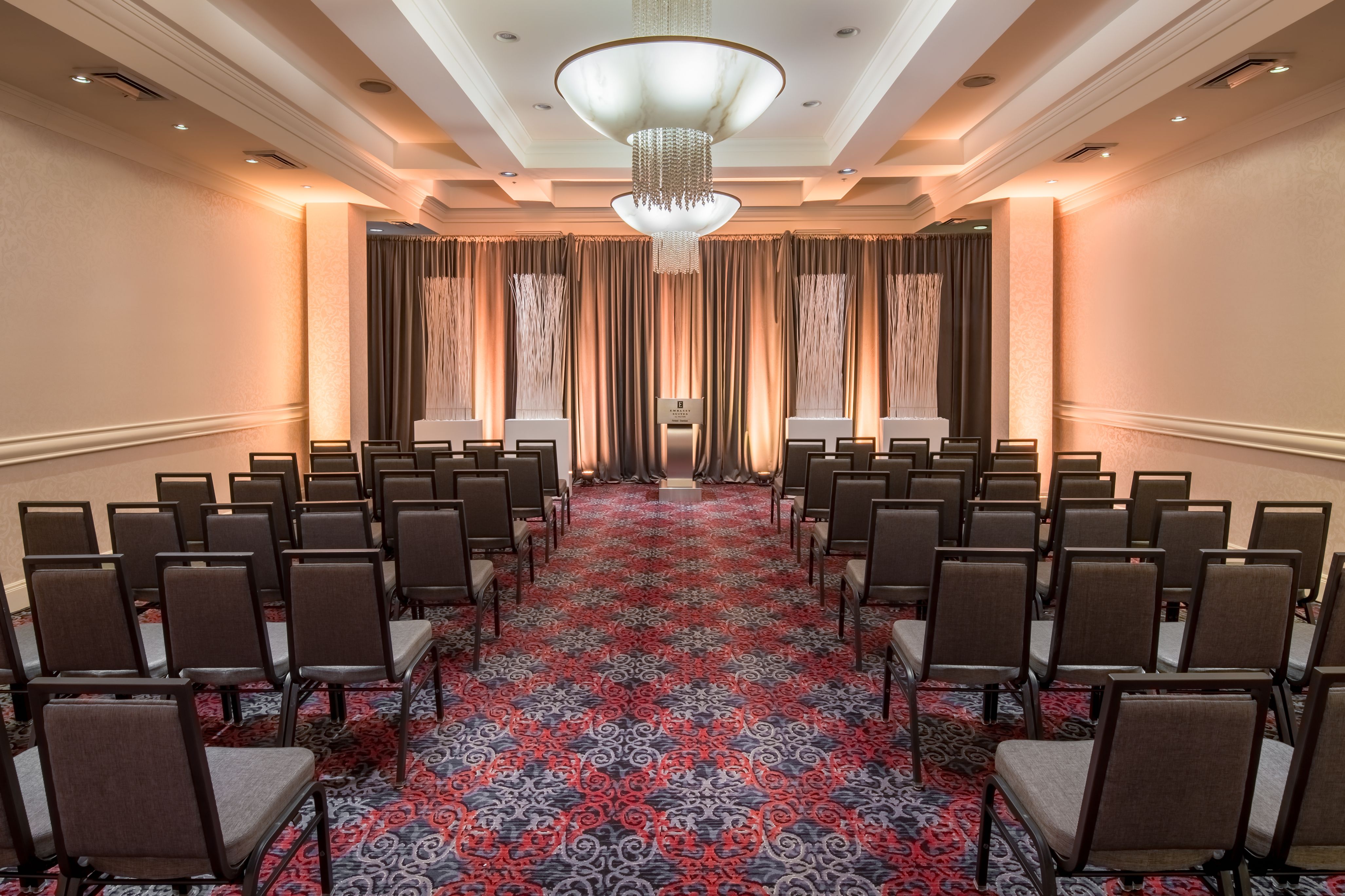 a room with chairs and a chandelier