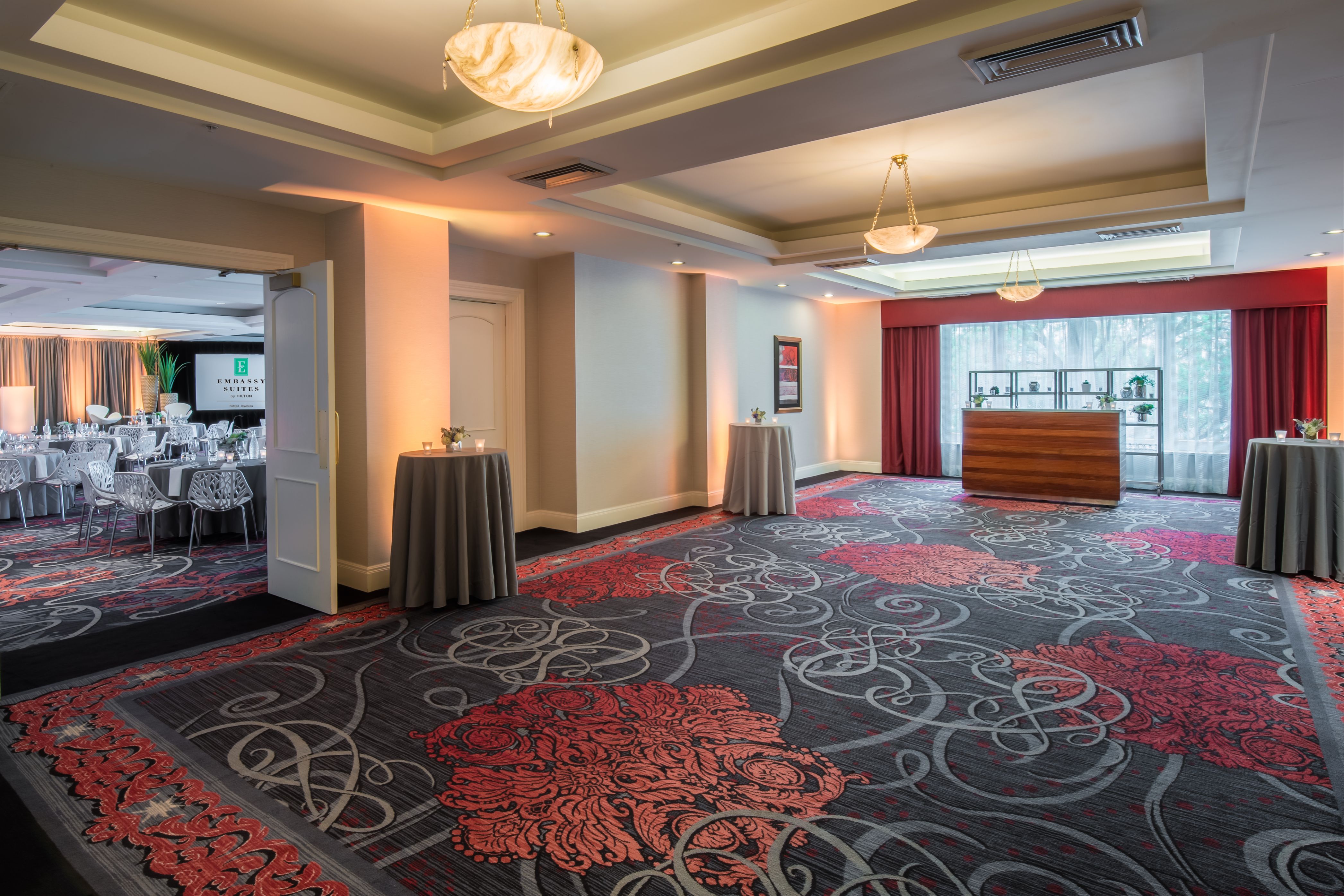 a room with a carpeted floor and tables