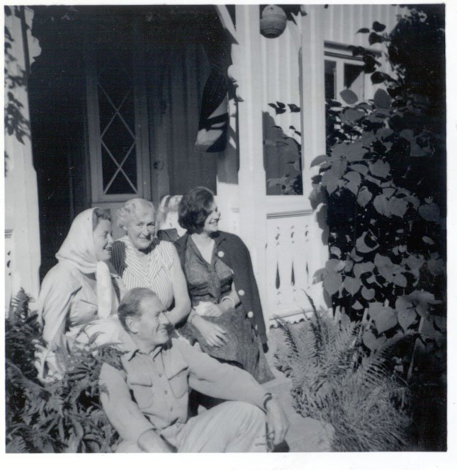 a group of people sitting on a porch