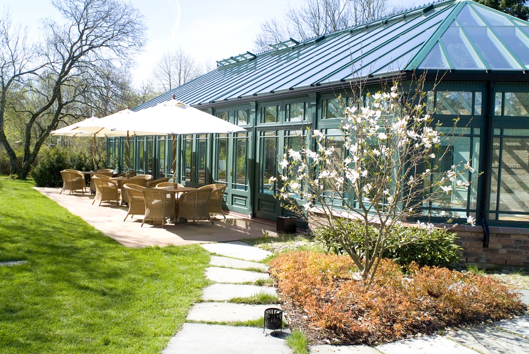 a patio area with chairs and umbrellas