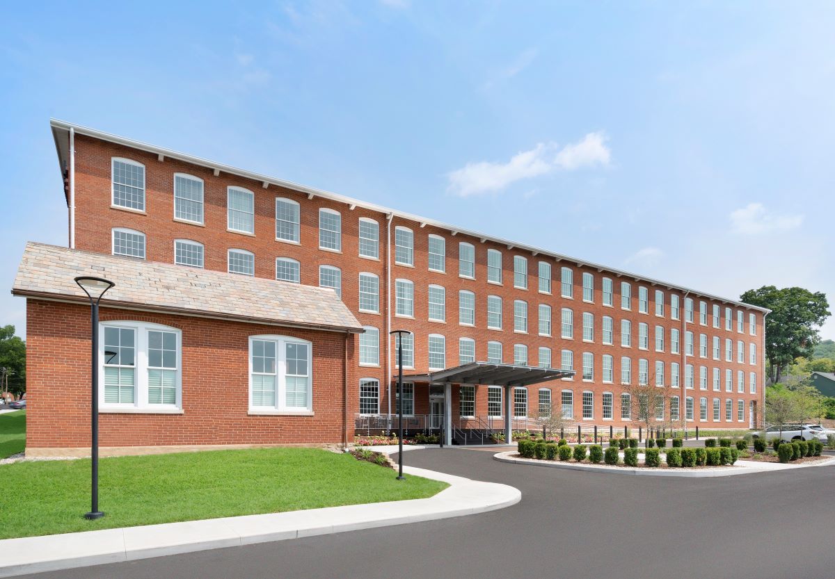 a large brick building with a driveway