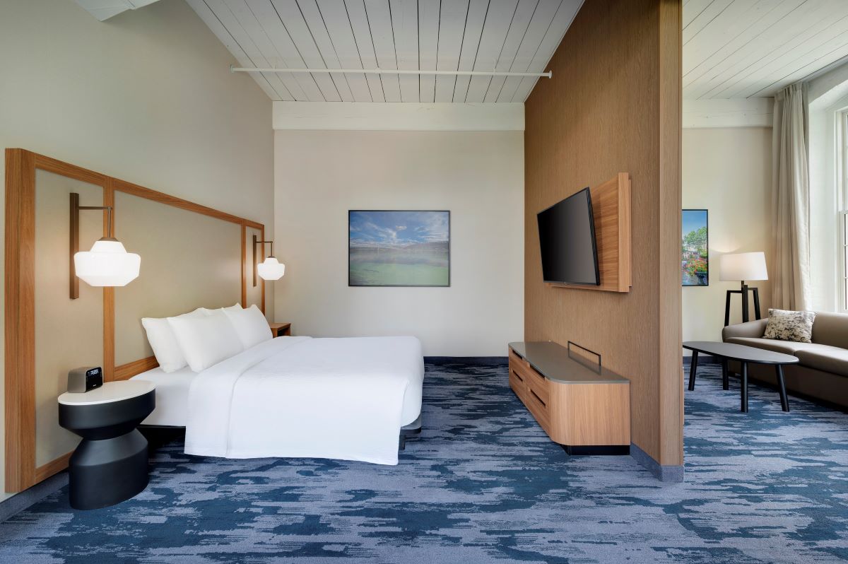 a room with a bed and a television