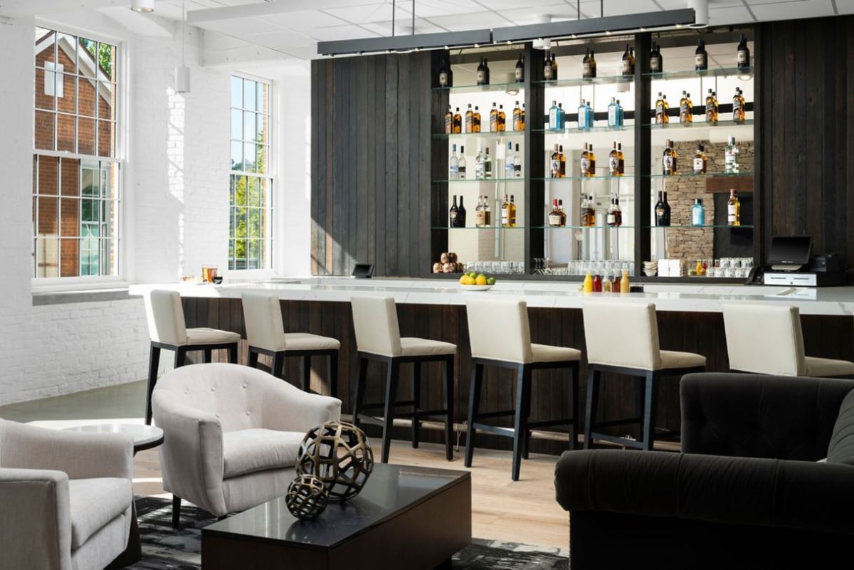 a bar with a shelf of liquor bottles