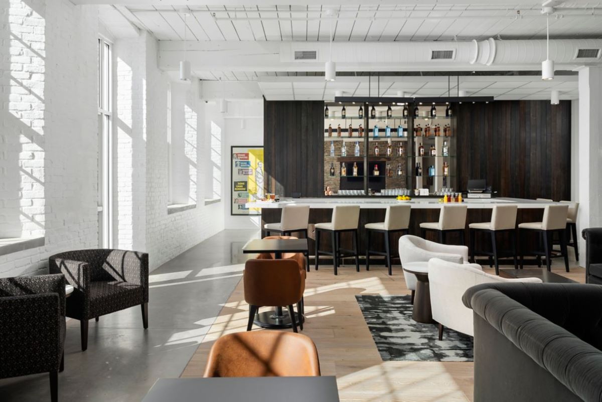 a room with a bar and chairs