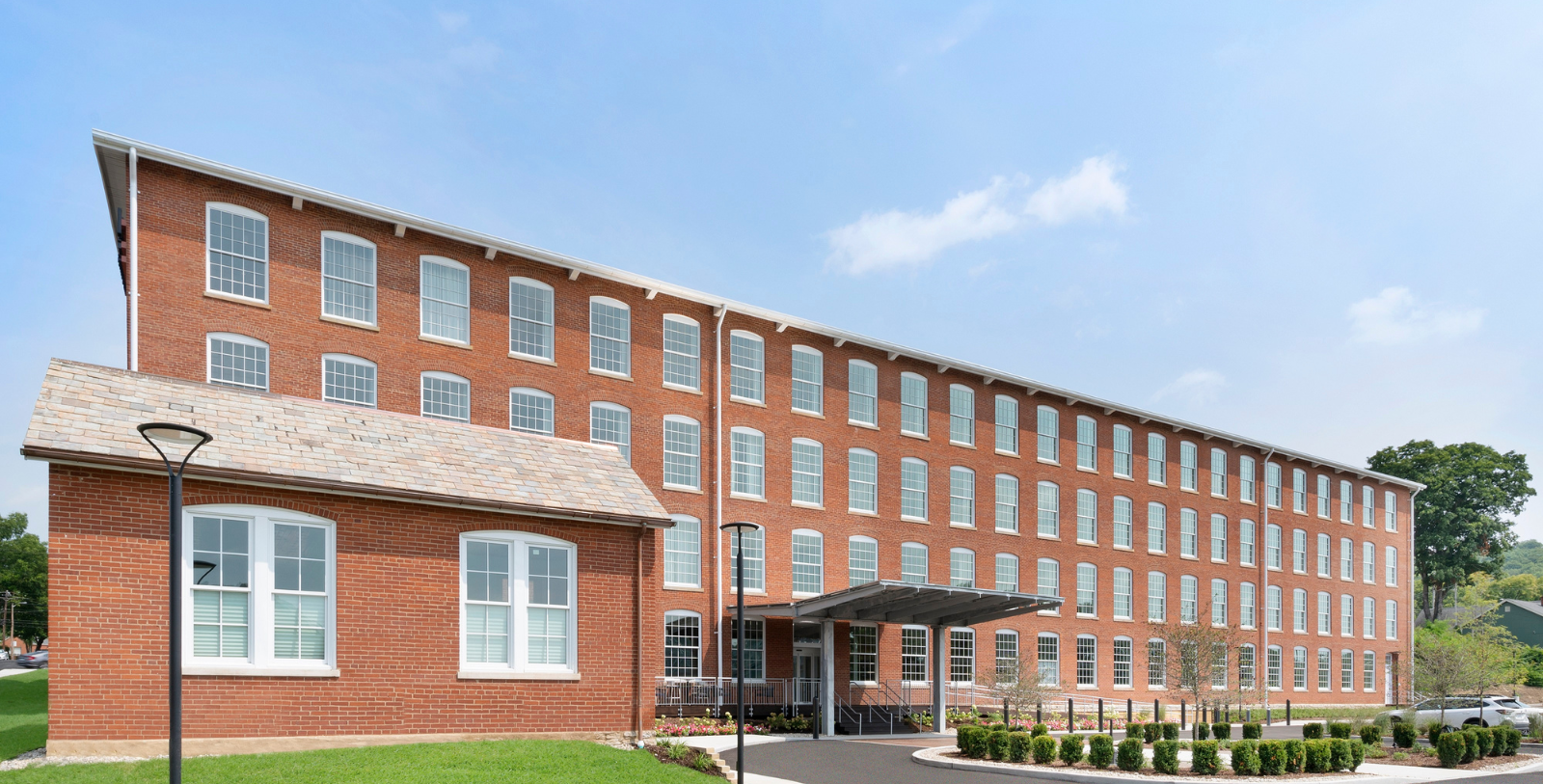 a building with a lawn and a walkway
