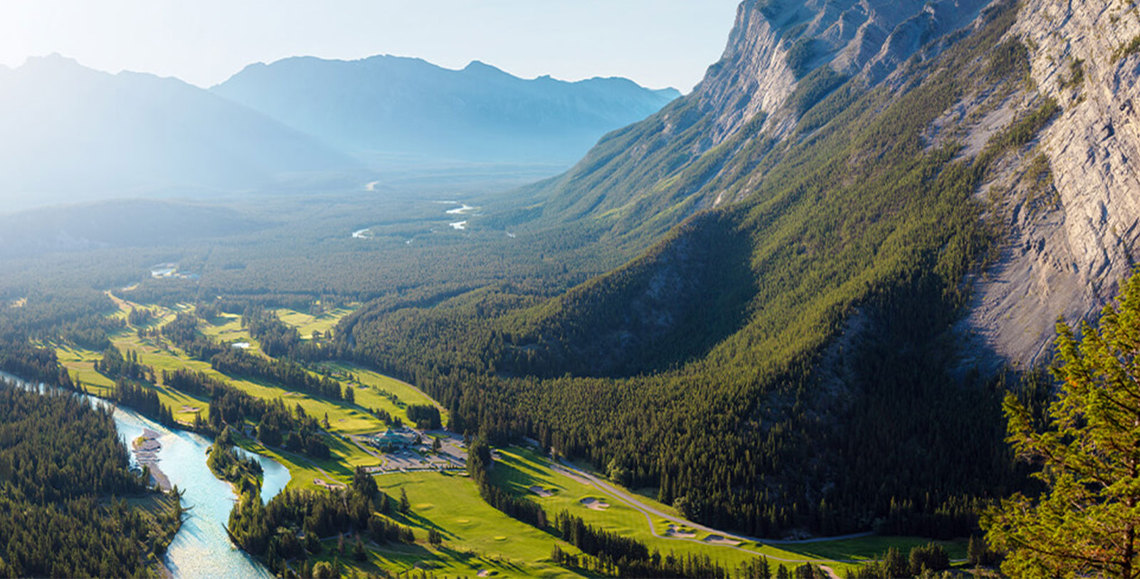 a landscape with a river and mountains